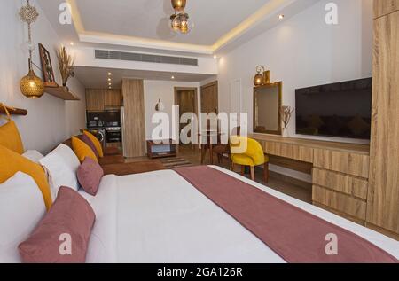 Living room lounge area in luxury studio apartment show home showing interior design decor furnishing with double bed Stock Photo