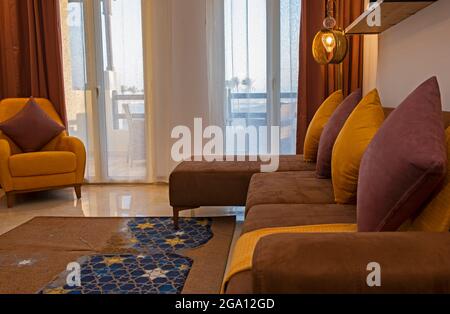 Living room lounge area in luxury apartment show home showing interior design decor furnishing with balcony Stock Photo
