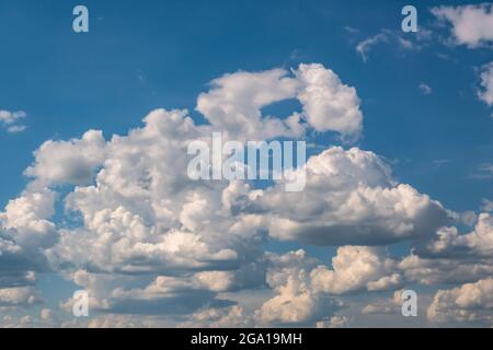 Blue sky background with big white tiny stratus cirrus striped clouds Stock Photo