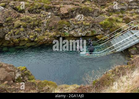 SILFRA, ICELAND - MAY 20, 2019: Scuba divers and snorkelers preparing entering in the water at Silfra rift, the place where Eurasian and the American Stock Photo