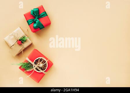 Three present boxes on beige background. Christmas holiday concept. Top view, flat lay, copy space. Stock Photo