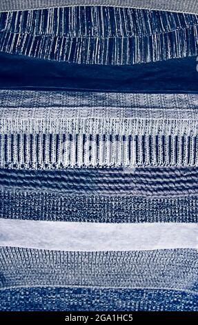 Warm knitted textile stack with the different texture in grey color palette close up Stock Photo