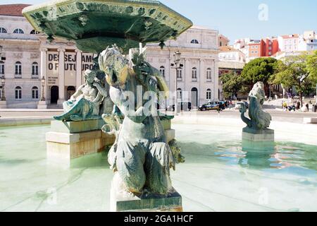 Sculptures of the North fountain in the Rossio Square, Queen Maria II National Theatre in the background, Lisbon, Portugal Stock Photo
