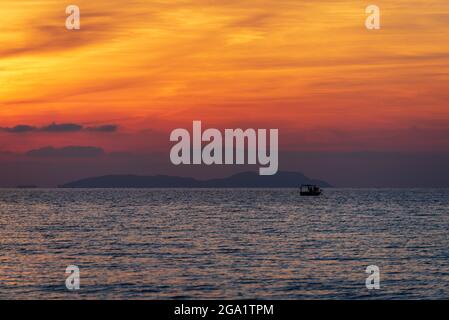 Fishing boat in the sea during sunset. Corfu island in Greece Stock Photo