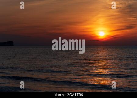 Amazing sunset over the sea. The northern part of the island of Corfu in Greece Stock Photo