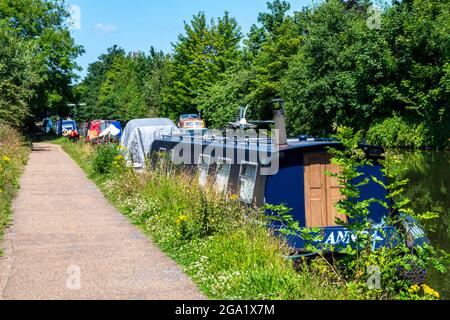 canal boats barges and narrowboats moored on the bridgewater canal towpath near sale in greater manchester uk. Stock Photo