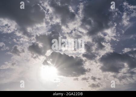 gray rain clouds and sunbeams Stock Photo