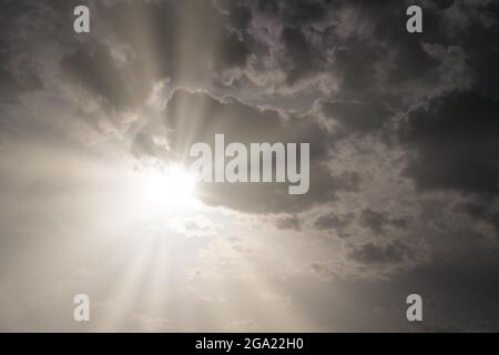 gray rain clouds and sunbeams Stock Photo