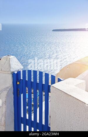 Views of the Aegean sea with blue gate in the foreground on Santorini island, Greece Stock Photo