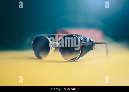 steampunk sunglasses with leather inserts with smoke on dark background Stock Photo