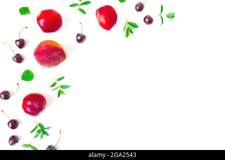Peaches with sweet cherry and mint on white background. Top view. Flat lay Stock Photo