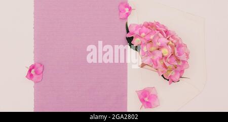 Flowers of pink hydrangea in an envelope with copy space for design. Stock Photo