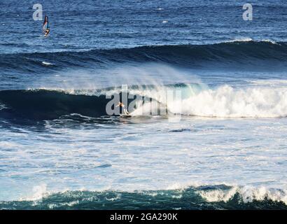 Surfing and windsurfing at Ho'okipa Beach Park near Paia; Maui, Hawaii, United States of America Stock Photo