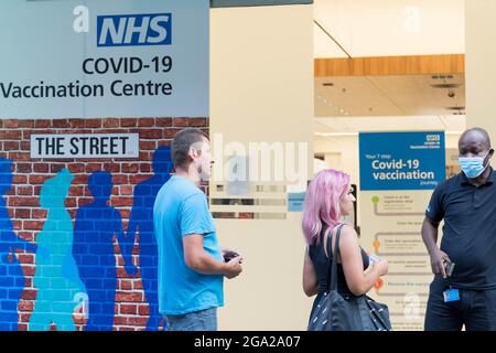 People queue for covid-19 tests outside NHS vaccination centre in Stratford Westfield centre, London Stock Photo