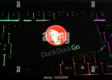 Viersen, Germany - June 1. 2021: Closeup of mobile phone screen with logo lettering of duckduckgo on computer keyboard Stock Photo