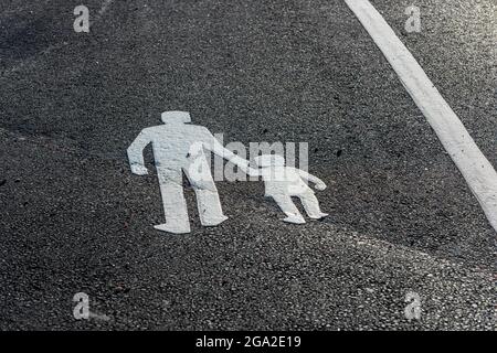 Painted symbol on the asphalt marking a walking path Stock Photo