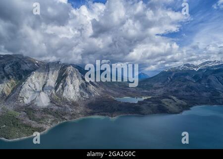 Aerial view of the lakes and dramatic Yukon mountain ranges under a stormy sky; Carcross, Yukon, Canada Stock Photo