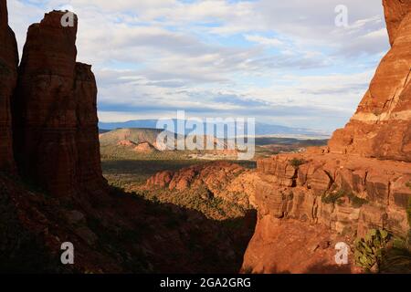 Sweeping wide-angle view of Sedona landscape with red rock buttes and mountains over valley floor; Sedona, Arizona, United States of America Stock Photo