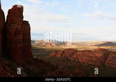 Sweeping wide-angle view of Sedona landscape with red rock buttes and mountains over valley floor; Sedona, Arizona, United States of America Stock Photo