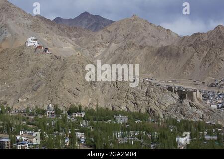 Tsemo Gompa (Namgyal Tsemo Monastery) above Leh Palace (Former Royal Palace) of Leh in the Indus Valley, with the city of Leh and its green vegetat... Stock Photo