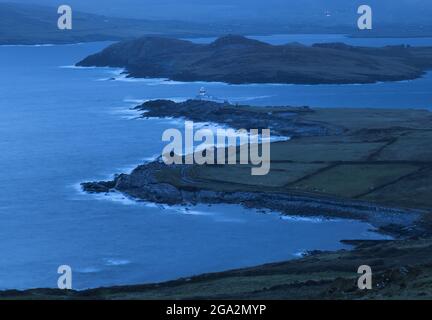 Aerial view of the waves breaking in predawn hours at Valentia Island Lighthouse on Cromwell Point, built on the site of the 17th century Cromwell ... Stock Photo
