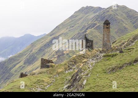 The ruins of the abandoned stone watch towers in the mountainside village of Girevi in the Tusheti National Park; Girevi, Kakheti, Georgia Stock Photo