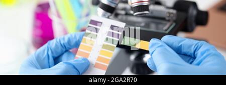 Scientist chemist holding ph test in his hands closeup Stock Photo