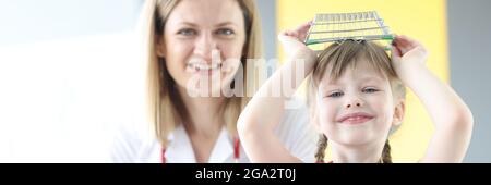 Little girl indulging in appointment with pediatrician in clinic Stock Photo