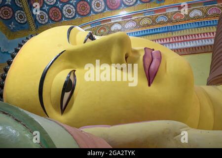 Close-up of the face of the longest reclining Buddha in South Asia in the Buddhist Monastery of Galagoda Shailatharama Viharaya Stock Photo