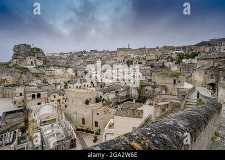 Cityscape panorama overlooking the ancient cave dwellings of the Sassi di Matera with Santa Maria de Idris church on the left Stock Photo
