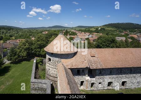 Overlooking the town and the round tower of the Cetatea Bethlen Medieval Castle in Racos; Racos, Transylvania, Romania Stock Photo