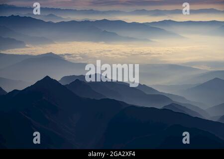 View of the Himalayan foothills from window on Dawn Kathmandu to Everest Flight over the Himalayas; Himalayas, Nepal Stock Photo