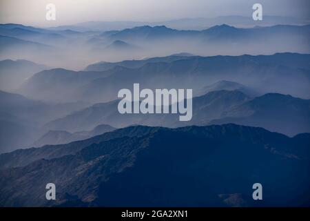 View of Himalayan foothills from window on dawn Kathmandu to Everest flight over the Himalayas; Nepal Stock Photo