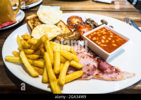 Full English breakfast on a plate in restaurant Stock Photo