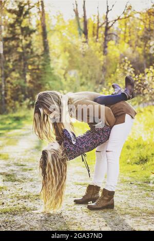 A mother spending quality time outdoors with her daughter in a city park; Edmonton, Alberta, Canada Stock Photo