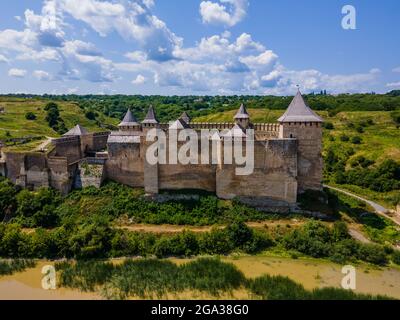 Aerial drone view of a medieval castle among the hills in summer afternoon