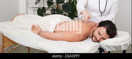 Reflexology. Treatment of back pain and tightness with acupuncture needles for a male patient Stock Photo