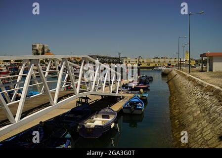 SETUBAL, PORTUGAL - Jul 04, 2021: A beautiful sunny day at the Setubal harbor in Portugal with fish boats parked around the dock Stock Photo