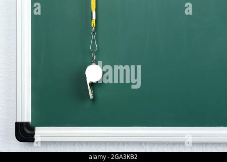 Whistle on blackboard background