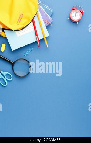 School backpack with stationery on the desk. Stock Photo