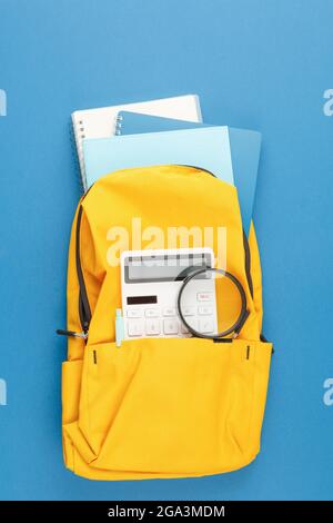 School backpack with stationery on the desk. Stock Photo