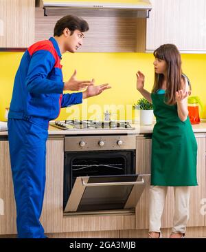 The woman with contractor at kitchen discussing repair Stock Photo