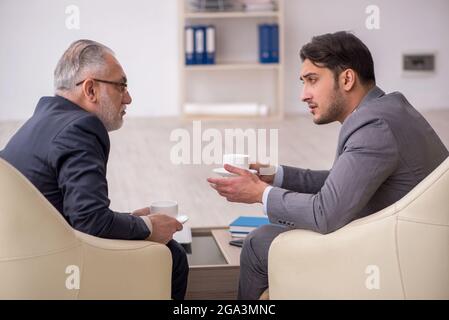 Two businessmen discussing project in the office Stock Photo