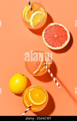 Composition with glasses of lemonade and citrus fruits on color background Stock Photo