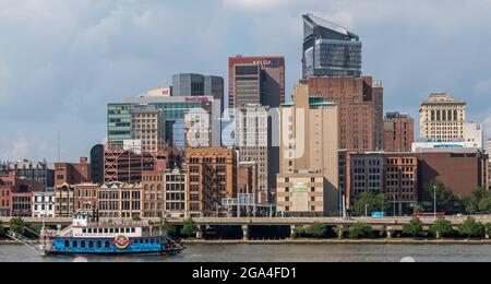 Part of downtown Pittsburgh, Pennsylvania, USA behind a ship from the Gateway Clipper Fleet traveling on the Monongahela river Stock Photo