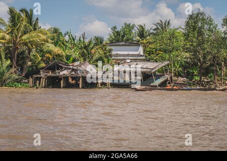 Destroyed house on the river bank. Mekong River in Vietnam, South East Asia. Vung Tau, Vietnam Stock Photo