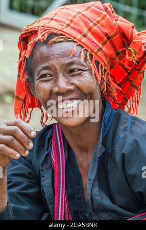 Market trader from Pa'o (Pa-o) hill tribe wearing orange turban selling vegetables in Kalaw, Shan State, Myanmar Stock Photo