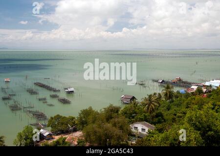 Thailand: Fish farms play an important role for communities near Ko Yo (Yo Island), Thale Sap Songkhla (Songkhla Lake). Songkhla was the seat of an old Malay Kingdom with heavy Srivijayan influence. In ancient times (200 CE - 1400 CE), Songkhla formed the northern extremity of the Malay Kingdom of Langkasuka. The city-state then became a tributary of Nakhon Si Thammarat, suffering damage during several attempts to gain independence. Stock Photo