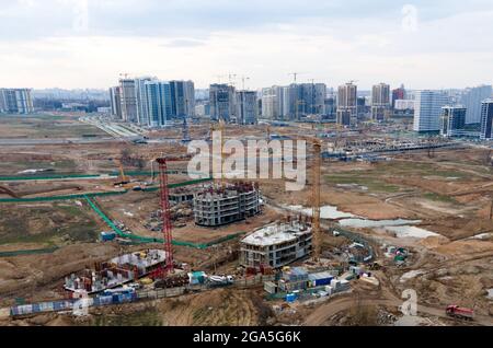 Arial view of a large construction site. Tower cranes in action. Housing renovation concept. Crane during formworks. Construction the buildings and re Stock Photo