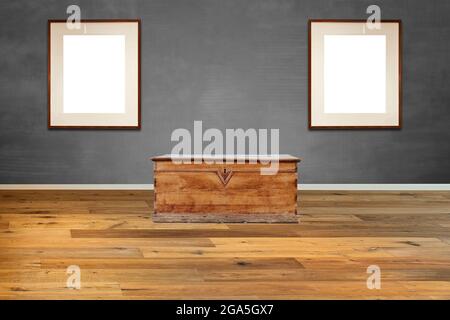Old-fashioned wooden chest against textured Grey wall Stock Photo